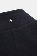 Close-up, angled top view of Montecore Cashmere Jacket navy’s stand-up collar with soft pure cashmere fabric and silver horse head pin.