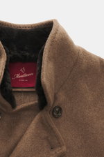 Close-up front perspective of Montecore Cashmere Jacket taupe melange showing pure cashmere fabric, soft touch, double-breasted four-button style, stand-up collar with detachable beaver fur trim, and Montecore logo button.

Description: Luxurious through 