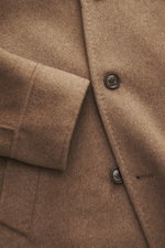Close-up front detail of Montecore Cashmere Jacket taupe melange showing soft pure cashmere fabric, buttons, and cuff from above.