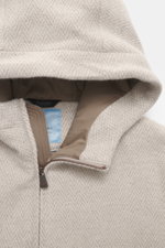 Close-up front view of Colombo Jacket beige melange hood showing soft kid cashmere and kid wool fabric with slim fit, two-way zipper, hood with drawstring, side seam pockets, smooth lining, and two inside pockets.