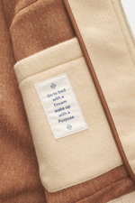Nahaufnahme des Innenfutters vom Jacob Cohen Cashmere Blouson beige, Detailansicht von weichem, reinem Cashmere mit Label und Stehkragen aus Rippstrick.