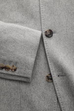 Brunello Cucinelli Cashmere Jacke hellgrau meliert, Nahaufnahme von Ärmel und Knöpfen, weiche, wasserabweisende Cashmere-Qualität, Slim Fit, Sakko-Design.