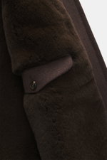 Close-up side view of Rifugio Blouson 'Favola' brown jacket sleeve showing soft wool-cashmere mix, buttoned cuff, and mink fur lining.