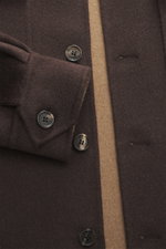 Close-up front view of Rifugio Overshirt brown, showcasing its slim fit, seven-button placket, turn-down collar, patch chest pockets with flap, sleeve cuffs with cuff, unconstructed design, made from a mix of virgin wool and cashmere with a soft touch.
