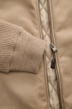 A close-up front view of the Agnona Cashmere Blouson taupe showing pure cashmere fabric, rib knit collar and cuffs, two-way zipper, and smooth quilted lining. Exclusive craftsmanship with sporty sophistication: The Cashmere Blouson by AGNONA combines fine