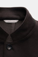 Close-up front view of Agnona Jersey Jacket Dark Brown collar and top button, showcasing wool-cashmere blend fabric, four-button style, and soft touch. Finest craftsmanship meets timeless elegance: this half-lined slim fit jacket features an adjustable la