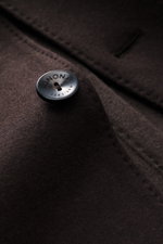 Close-up front angle of Agnona Jersey Jacket Dark Brown button on soft wool-cashmere blend fabric, showcasing finest craftsmanship and timeless elegance.