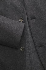 Agnona Jersey jacket dark grey melange close-up from a front angle showing wool-cashmere fabric, four-button style, patch hip pocket, and soft texture. Finest craftsmanship meets timeless elegance: This half-lined jersey jacket made from a wool-cashmere b