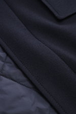 Close-up front view of the Brioni Cashmere jacket navy showing slightly elastic cashmere, soft feel, lamb leather details, and quilted lining fabric.