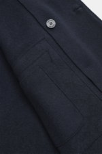 Close-up front view of the navy Lunaria Cashmere Cashmere Jacket highlighting its pure cashmere fabric, soft texture, flap pocket, notch collar, and signature button.
