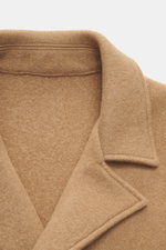 Close-up front view of the Lunaria Cashmere Cashmere Jacket beige, showcasing its notch collar and soft pure cashmere fabric, Slim Fit, double-breasted three-button style, front flap pockets, rear side vents, unlined with one inside pocket, timeless elega