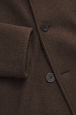 Close-up front view of the Lunaria Cashmere Cashmere Jacket Dark Brown, showcasing pure cashmere fabric, slim fit, double-breasted three-button style, notch collar, and front flap pockets. Timeless elegance, masterfully staged: The exclusive, lightweight 