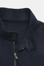 Close-up front view of the navy Lunaria Cashmere Cashmere Blouson featuring a stand-up collar, two-way zipper, and buttons, made of pure cashmere with a very soft touch, slim fit, slanted front pockets, elastic hem and sleeve cuffs, unlined.