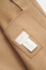Close-up front view of Lunaria Cashmere Cashmere Blouson beige showing pure cashmere fabric, very soft touch, slim fit, two-way zipper, stand-up collar, slanted front pockets, elastic hem and sleeve cuffs, and unlined interior.