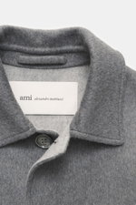 Close-up front view of Ami Paris Grey Jacket's collar and label, made of wool and cashmere with a soft touch and slim fit. Stylish through the transitional season: This jacket by AMI PARIS convinces with a casual cut made of wool and cashmere – a versatil