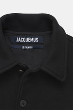 Front close-up of Jacquemus Blouson black showing turn-down collar, smooth button placket, pure new wool, soft touch, oversized fit, piped front pockets, elastic hem and sleeve cuffs.