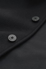 Close-up view of the Jacquemus Blouson black showing pure new wool fabric with soft touch, oversized fit, turn-down collar, smooth button placket, piped front pockets, elastic hem and sleeve cuffs.