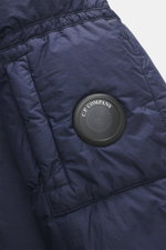 Close-up front view of C.P. Company Down jacket dark blue in high-quality ripstop microfiber with lightly textured feel, wind- and water-repellent, warm down filling, garment dyed, slim fit, robust two-way zipper, practical hood, front zipper pockets, sle