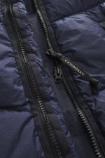 Close-up view of the C.P. Company Down jacket dark blue front zipper area, showing high-quality ripstop microfiber with a lightly textured feel, wind- and water-repellent fabric, warm down filling, garment dyed finish, slim fit, robust two-way zipper with