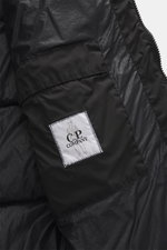 Close-up interior view of C.P. Company Down jacket 'Nycra-R' black showing high-quality, recycled microfiber, warm down filling, slim fit, two-way zipper, wind flap with press studs, hood with drawstring, zipper chest pockets, concealed zipper front pocke