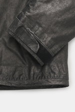 Close-up view of the sleeve and hem of the C.P. Company Jacket 'Metropolis' dark grey, showing high-quality microfiber with smooth feel, wind- and water-repellent fabric, warm wool inlay, slim fit, durable zipper, high-closing collar, hood with drawstring