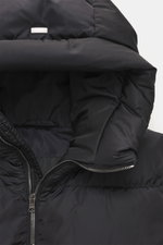 Close-up front view of the black Herno Down jacket featuring high-quality microfiber, soft touch, warm down filling, regular fit, durable zipper, practical hood with drawstring, slanted hip pockets with zipper, smooth lining fabric, adjustable hem width, 