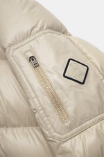 Close-up view of the sleeve of the Herno Down jacket beige showing a zipper pocket with patch, highlighting high-quality microfiber, smooth feel, warm down filling, regular fit, two-way zipper, detachable hood, slanted hip pockets with zipper, soft lining