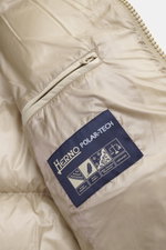 Close-up interior view of Herno Down jacket beige showing high-quality microfiber fabric, smooth feel, warm down filling, regular fit, two-way zipper, detachable hood, slanted hip pockets with zipper, soft lining fabric, zipper pocket with patch on the sl