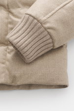 Herno Down jacket beige close-up from above showing elastic virgin wool fabric, soft touch, warm down filling, regular fit, rib knit sleeve cuff.
