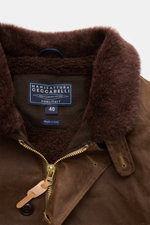 Close-up front view of the Manifattura Ceccarelli Waxed jacket 'Deck Jacket' brown showing the alpaca wool collar trim, robust zip, and label.