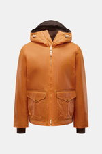 Front view of the Manifattura Ceccarelli Waxed jacket 'Blazer Coat' orange, a cropped waxed cotton jacket with water repellent finish, hood with peak, adjustable hem, large front pockets with snap buttons, windbreaker cuffs, and super-soft wool lining. Th