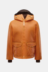 Front view of the Manifattura Ceccarelli Waxed jacket 'Blazer Coat' orange, a cropped waxed cotton jacket with water repellent finish, hood with peak, adjustable hem, large front pockets with snap buttons, windbreaker cuffs, and super-soft wool lining. Th