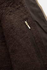 Close-up view of the super-soft wool lining and gold zipper of the Manifattura Ceccarelli Waxed jacket 'Blazer Coat' orange, showing detailed texture and stitching from an angled perspective. The waxed jacket combines adventure spirit with comfort: waxed 