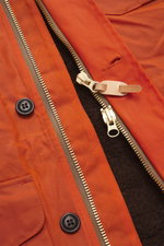 Close-up front view of Manifattura Ceccarelli Waxed jacket 'Weekender' orange showing waxed cotton, typical material feel, water-repellent fabric, slim fit, light pure wool padding, two-way zipper, wind flap with buttons, patch chest and hip pockets with 