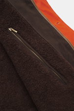 Close-up view of the soft teddy lining and zipper detail inside the Manifattura Ceccarelli Waxed jacket 'Weekender' orange, showcasing waxed cotton, typical material feel, water-repellent, slim fit, light padding made of pure wool, two-way zipper, wind fl