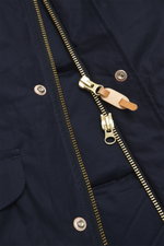 Close-up front view of the Manifattura Ceccarelli Down jacket 'Fisherman' navy, showing the two-way brass zipper with leather pull, press stud wind flap, and quilted pure cotton fabric with soft touch, regular fit, warm down filling, high-closing collar w