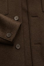 Harris Wharf London Wool jacket dark brown close-up from above showing felted virgin wool texture, buttons, buttoned breast pocket, and cuff details. Casual and cosy: This cropped wool jacket by HARRIS WHARF LONDON, made of felted virgin wool, has a clean