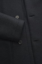 Close-up front view of Harris Wharf London Wool jacket dark navy, showing knitted and felted virgin wool, heavy sturdy quality, raw-edge finish, slim fit, four-button placket, turn-down collar, patch pockets, and unconstructed design.