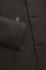 Close-up view of Harris Wharf London Wool jacket dark brown, showing knitted and felted virgin wool, heavy sturdy quality, raw-edge finish, slim fit, four-button placket, turn-down collar, patch pockets, and unconstructed design.
