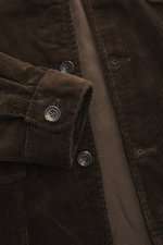 Nahaufnahme der dunkelbraunen Polo Ralph Lauren Cordjacke 'Finley' im Slim Fit mit weichem Baumwollcord, Reverskragen, Knopfleiste und Manschetten, fotografiert von oben.