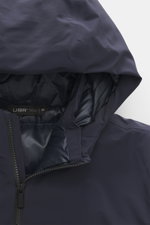 Close-up front view of UBR Down jacket 'Phantom' dark blue showing water-repellent elastic microfiber hood, two-way zipper, smooth lining fabric, and high-closing stand-up collar.