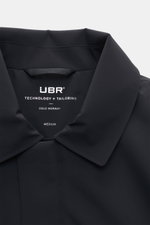 Close-up front view of the collar and label inside the UBR Short coat 'Regulator Coat' black, showcasing Scandinavian simplicity.

<p>The model 'Regulator Coat' by Norwegian label UBR is lightweight and exceptionally functional – Scandinavian simplicity d
