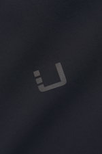 Close-up front view of the reflective logo on the UBR Short coat 'Regulator Coat' black, showcasing high-quality microfibre fabric.

Description: <p>The model 'Regulator Coat' by Norwegian label UBR is lightweight and exceptionally functional – Scandinavi