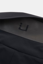 Close-up top-down view of the inner collar and logo of UBR Short coat 'Regulator Coat' black, showcasing high-quality microfibre and smooth feel. 

<p>The model 'Regulator Coat' by Norwegian label UBR is lightweight and exceptionally functional – Scandina