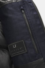 Close-up front view of UBR Merino Down Jacket 'Savile' navy melange showing pure merino wool fabric, zippered pocket, and label.

Description: <p>With the down jacket 'Savile' by UBR, we are well prepared for the next cold season, as this clean model feat