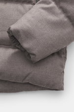 Close-up view of the sleeve and quilted fabric of the UBR Merino Down Jacket 'Savile' grey-brown melange, showing pure merino wool and warming down filling.