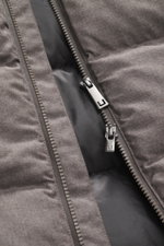 Close-up front view of the UBR Merino Down Jacket 'Savile' grey-brown melange zipper showing fine merino wool fabric and smooth lining. With the down jacket 'Savile' by UBR, we are well prepared for the next cold season, as this clean model features a war