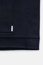 Close-up front view of the navy 04651/ A trip in a bag Jacket 'Double Blouson' showing wool blend fabric and label.

Description: Eyecatcher for the transitional season: The lightweight jacket in aviator style from 04651/ A TRIP IN A BAG impresses with a 