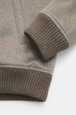 Close-up side view of the cuff and hem of the Eddy Monetti Cashmere blouson 'Rius' grey melange, showing pure cashmere fabric and ribbed knit details. High-quality blouson by EDDY MONETTI: The model 'Rius' impresses with a comfortable fit made of pure cas