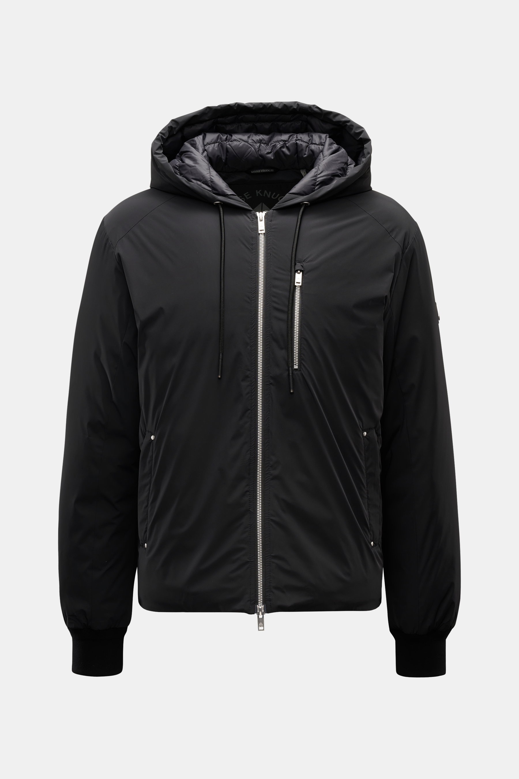 Front view of Moose Knuckles Down jacket 'Northdale' black with hood, two-way zipper, zippered chest and side pockets, ribbed cuffs.

<p>Casual outdoor looks for colder days: With its sporty hoodie design, the down jacket by MOOSE KNUCKLES becomes the ide